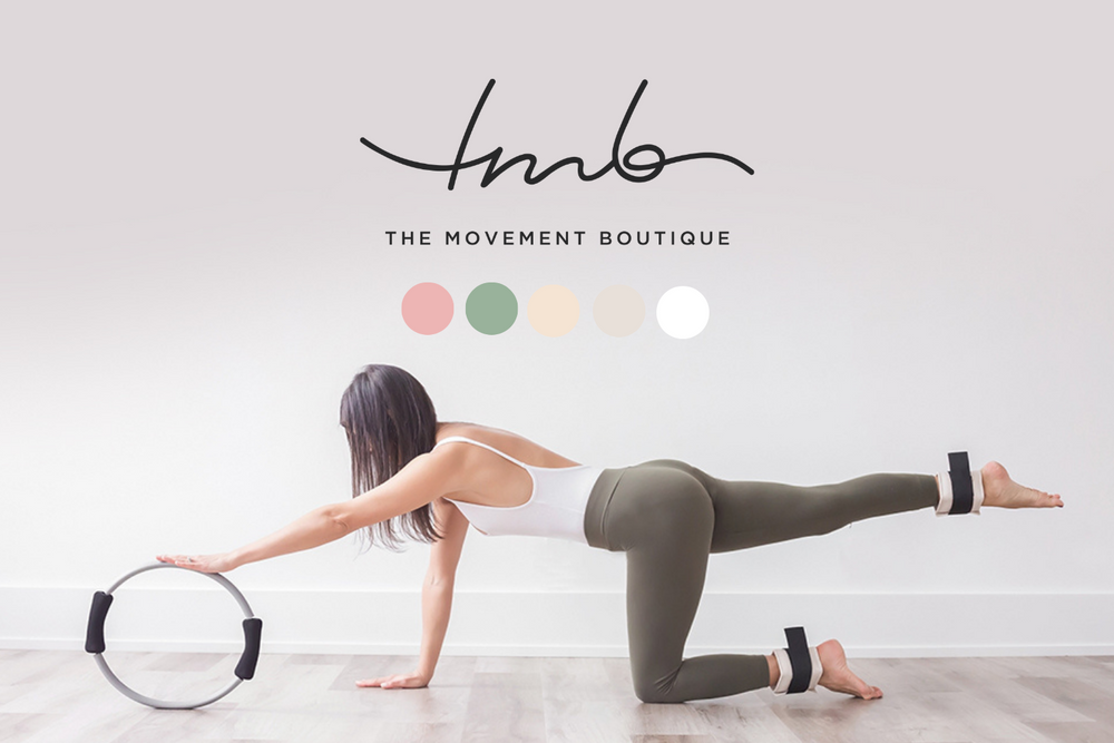 Woman demonstrating bird dog exercise pose with pilates ring in minimal studio setting.