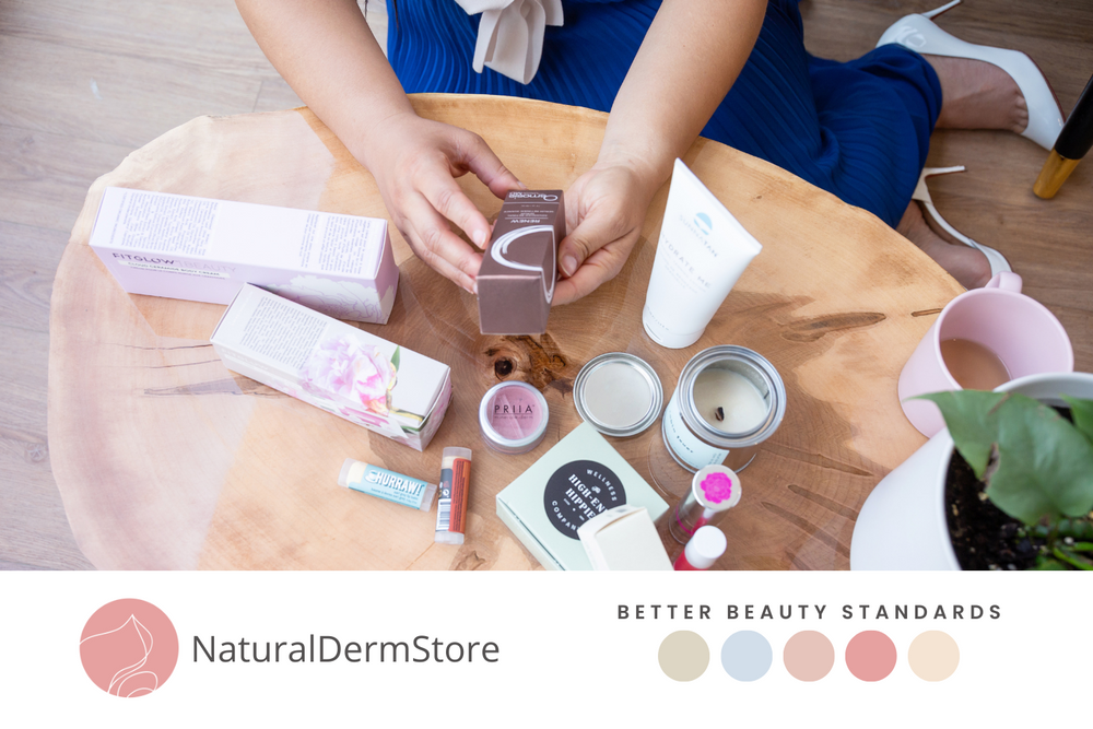 Flatlay of natural skincare products and beauty items on wooden surface.