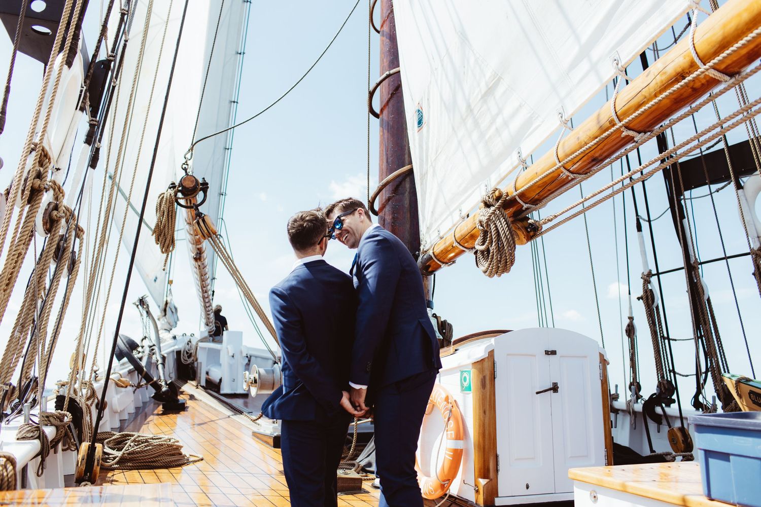 two grooms look at each other on the bluenose schooner