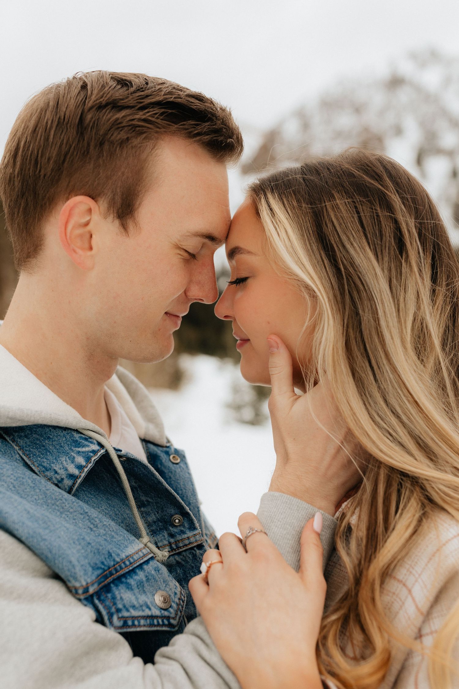 Man holding woman's face, foreheads together, eyes closed