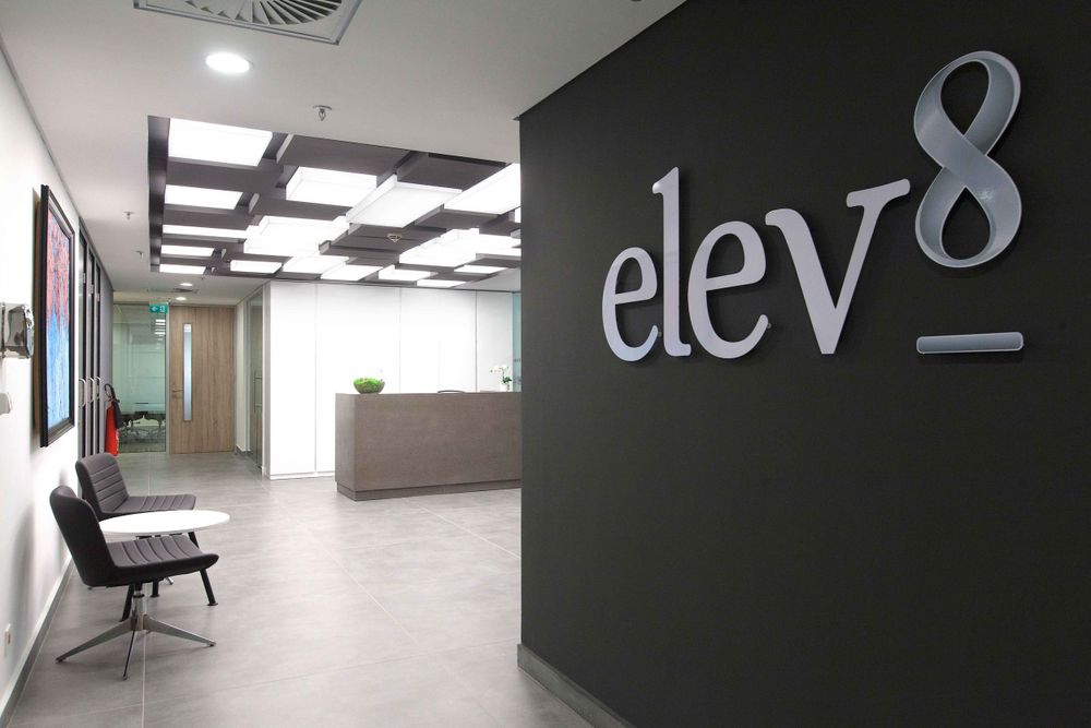 Minimalist office hallway with modern signage, geometric lighting, and clean architectural lines.
