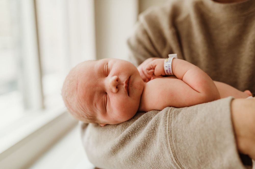 newborn baby in the fathers arms