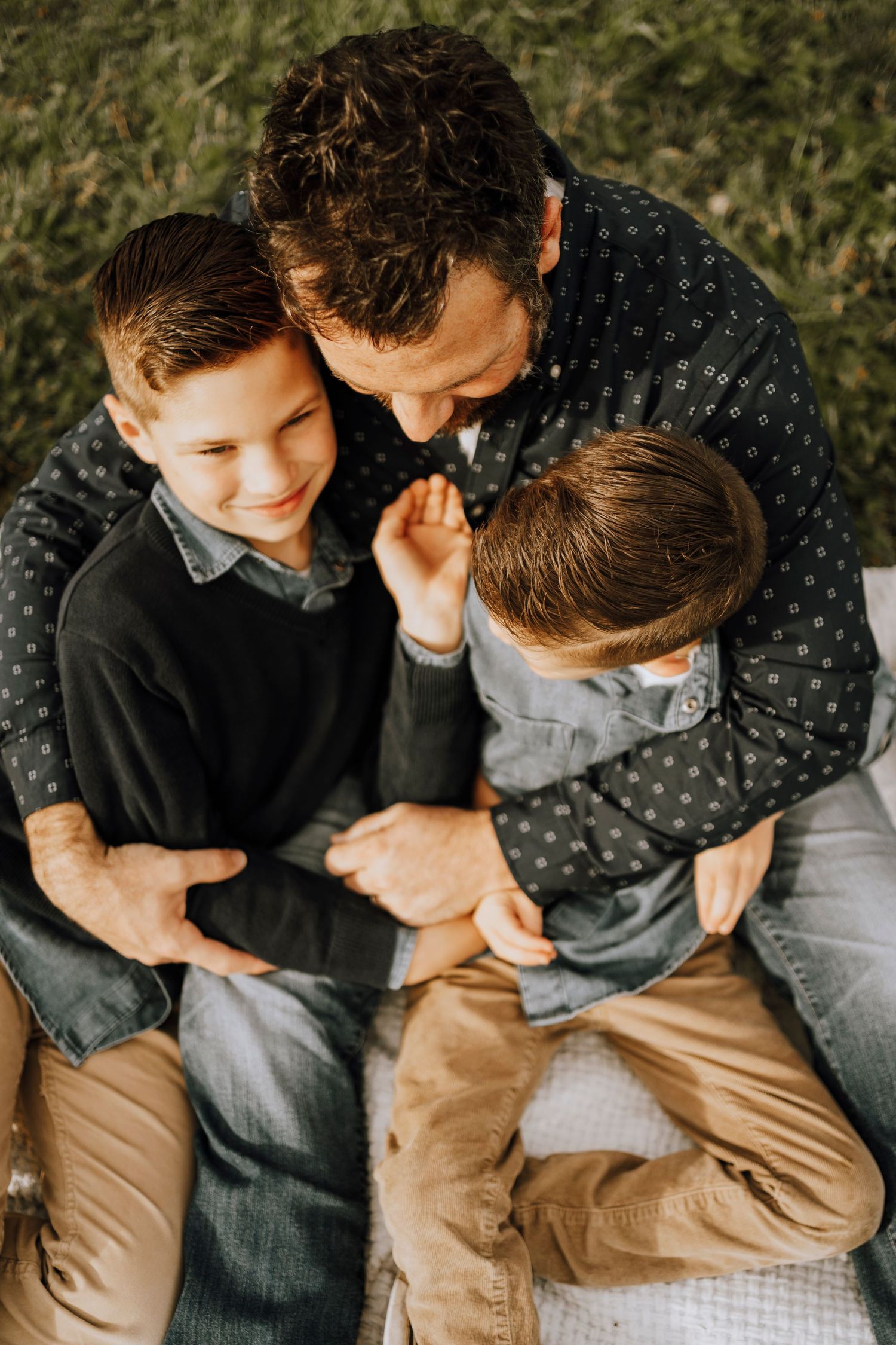 Intimate family portrait showing tender moment between family members.