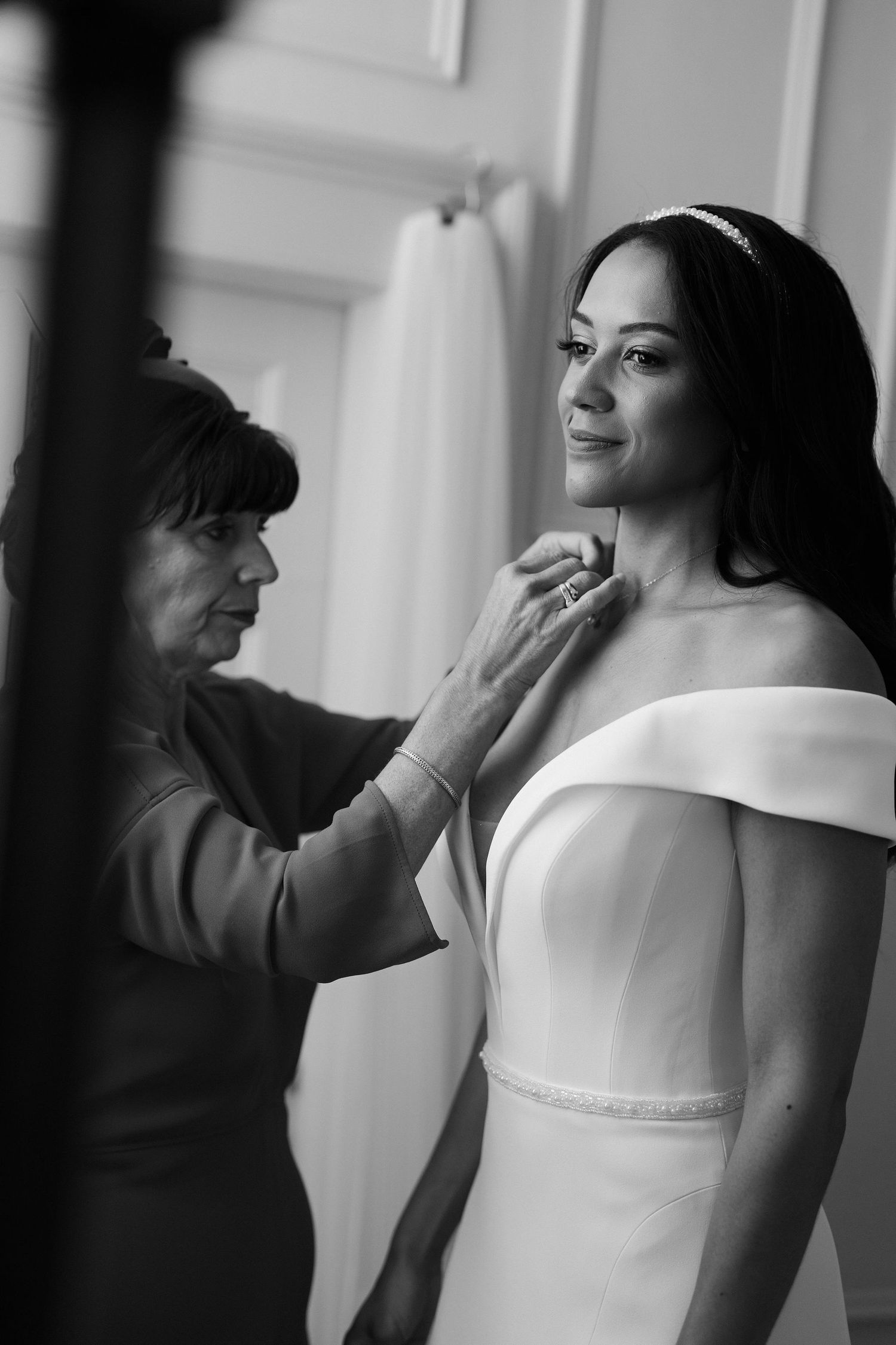 mum-putting-brides-jewellery-on-stockton-house-wedding-shropshire