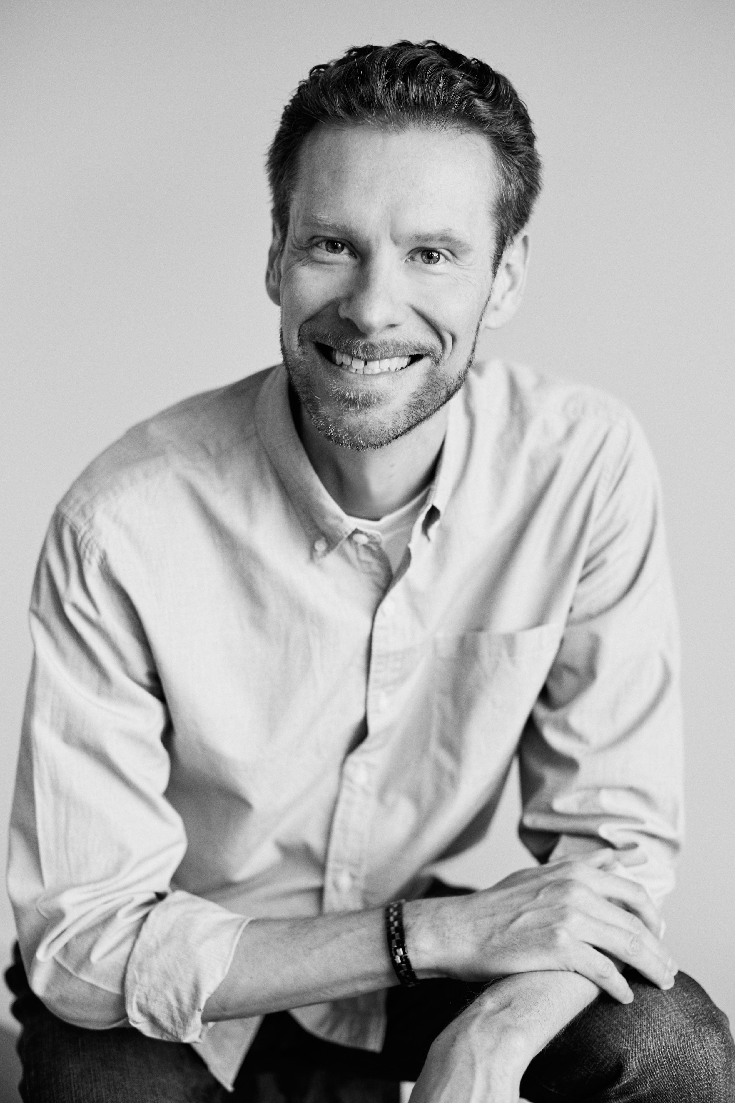 Series of black and white headshots showing person in white shirt with various expressions.