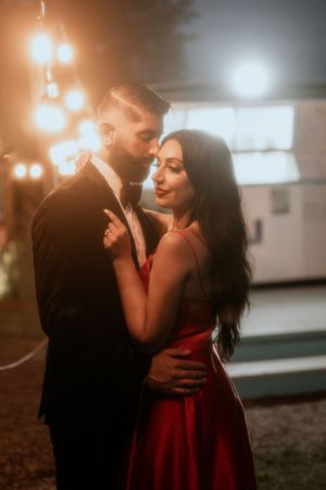 Romantic evening portrait with soft lighting and elegant formal attire.