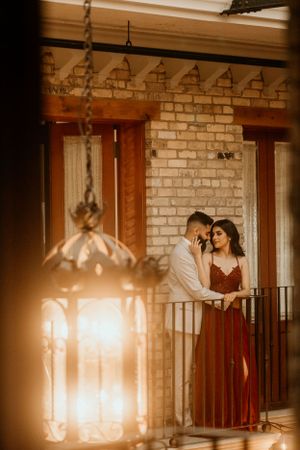 Romantic scene with vintage lantern and brick wall creating warm atmospheric lighting.
