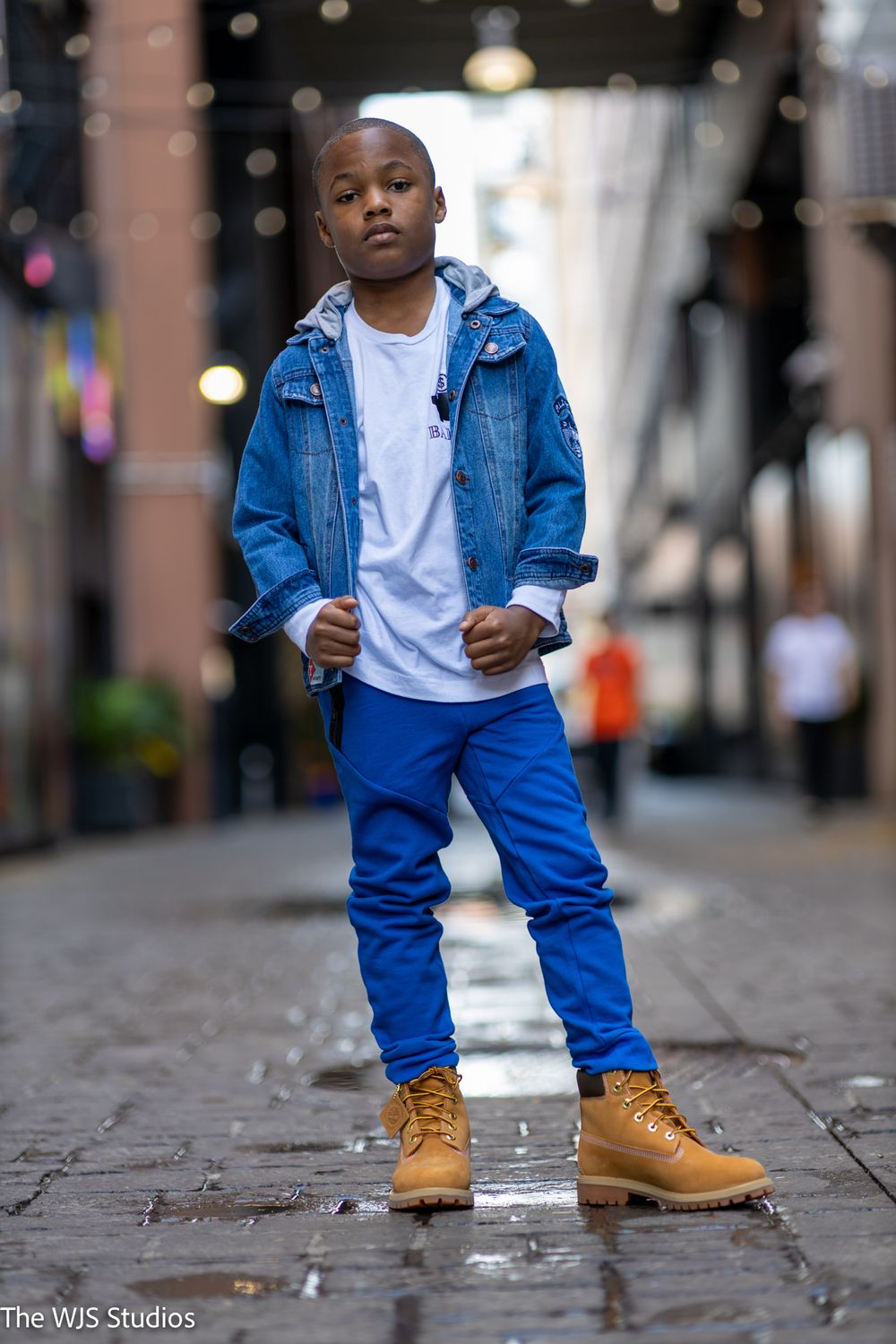 little boy in blue jogging pants, timberland boots and jean jacket