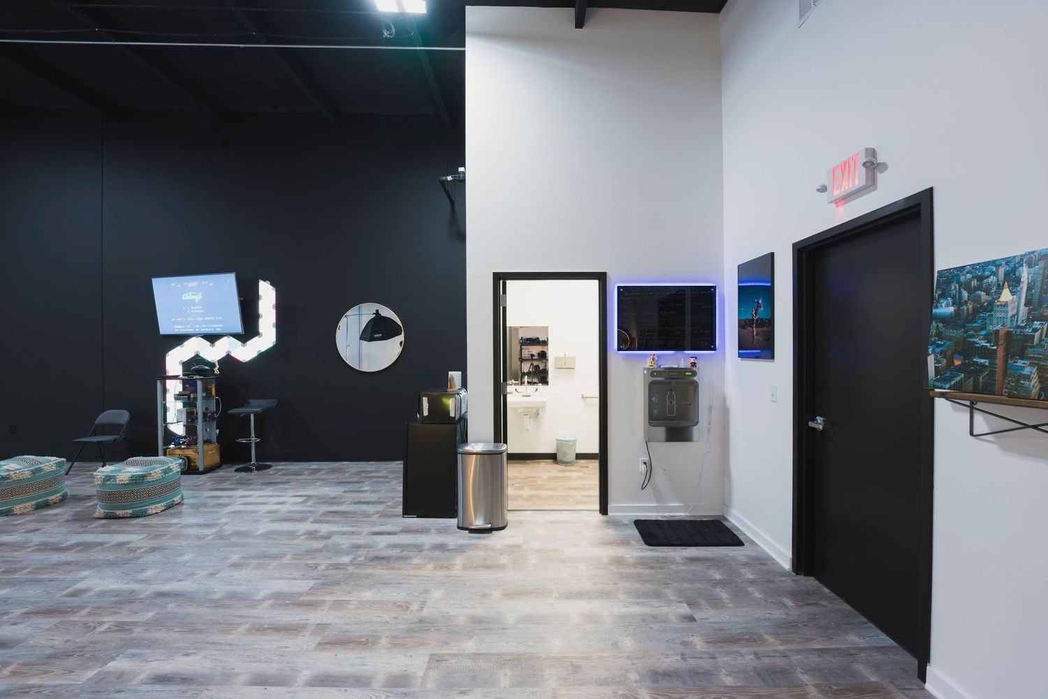 Studio hallway with black accent wall, professional equipment and modern amenities.