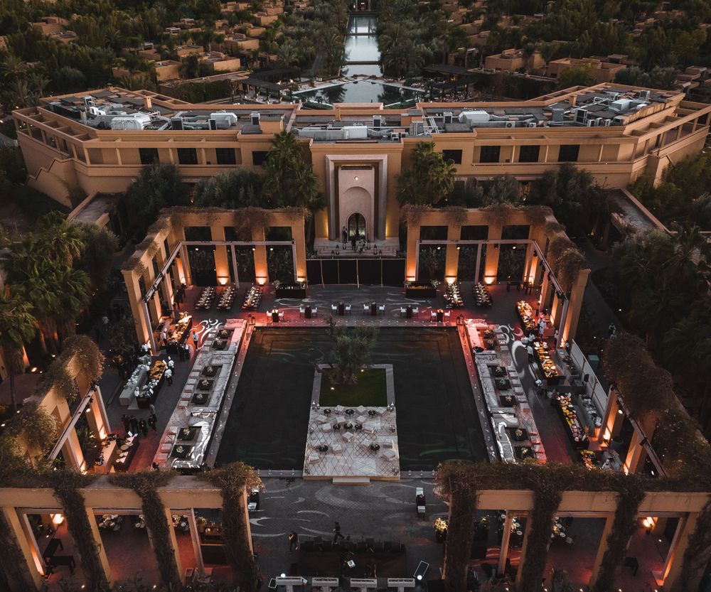 Aerial view of a neoclassical courtyard venue lit up for an evening event.