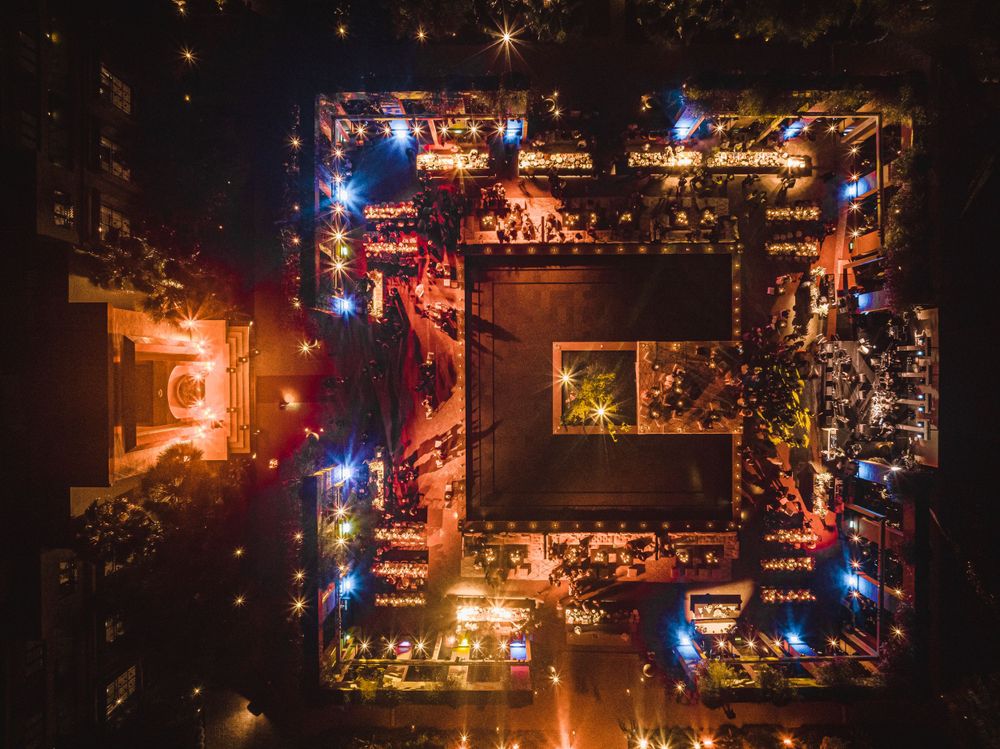 Night aerial view of illuminated city streets forming a perfect square pattern.