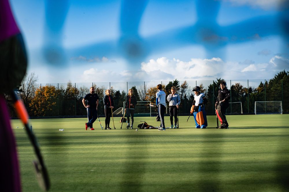 Field hockey team training session on outdoor pitch in Gloucestershire