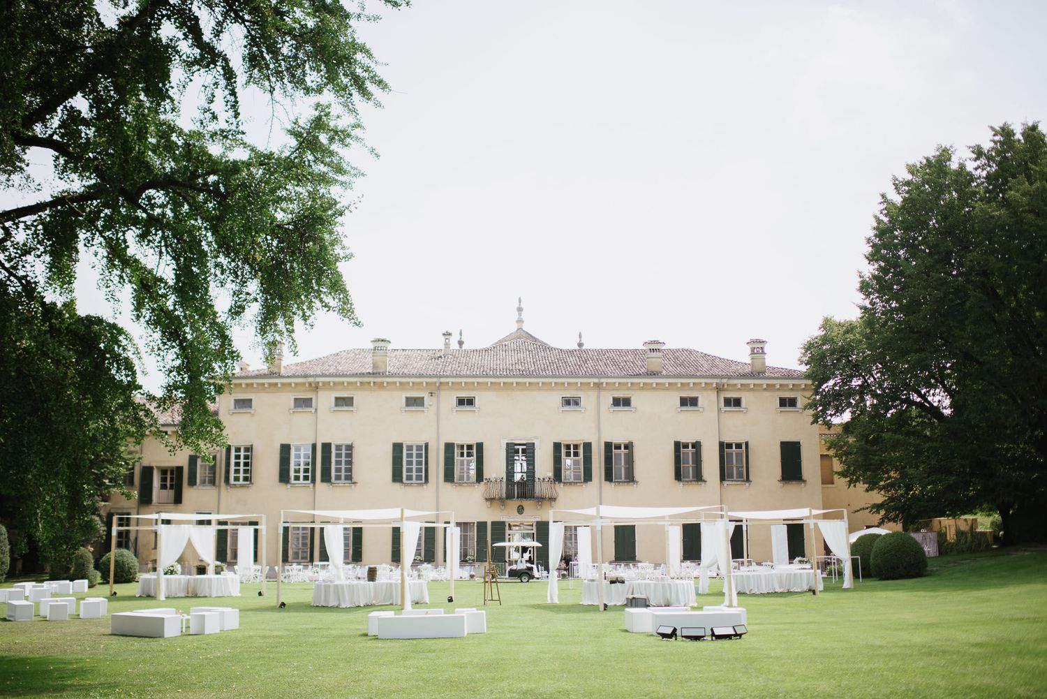 Grand white historic villa with manicured lawn and garden perfect for outdoor wedding celebrations.