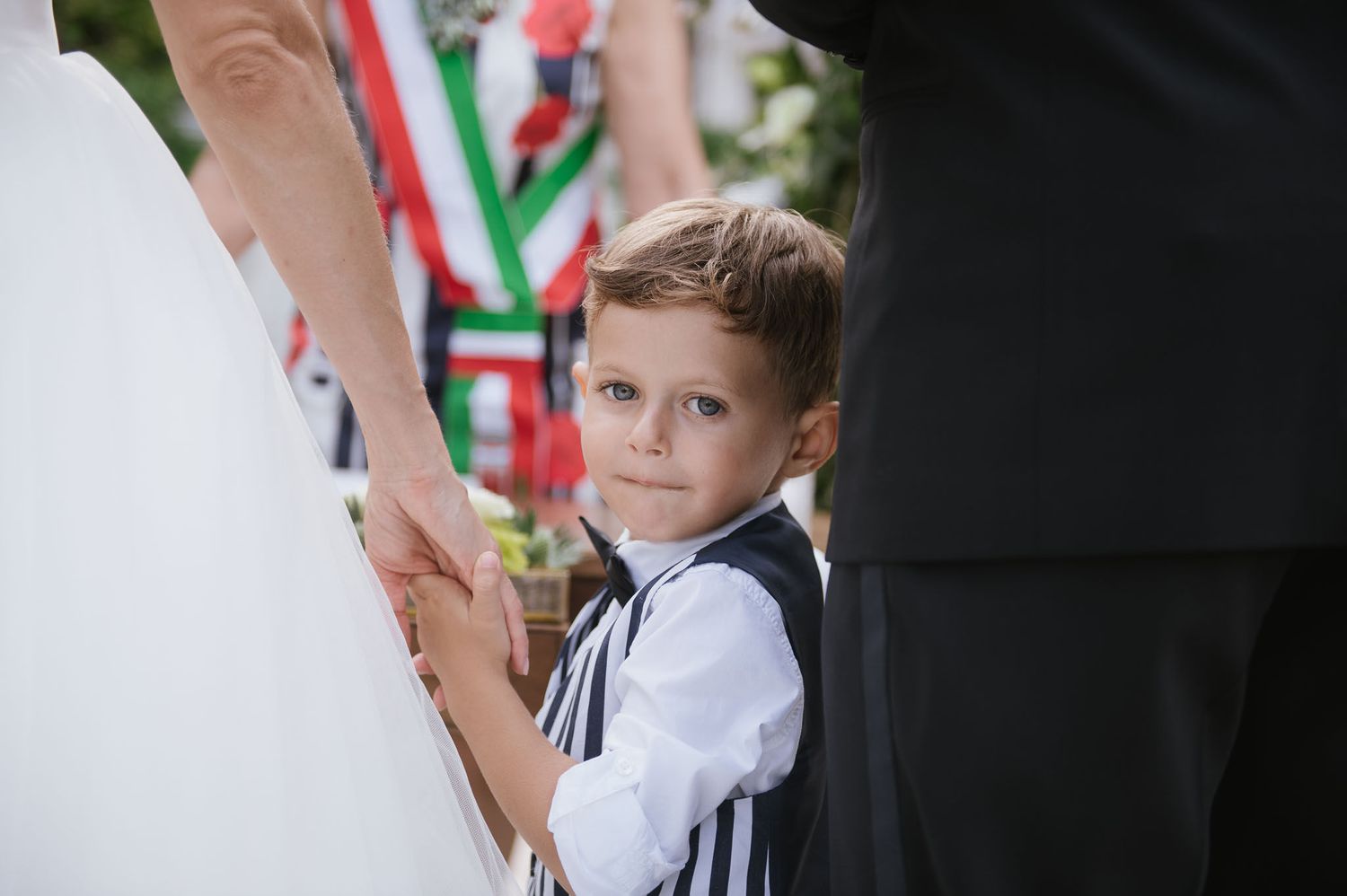 A touching black and white wedding photo moment in a garden setting.