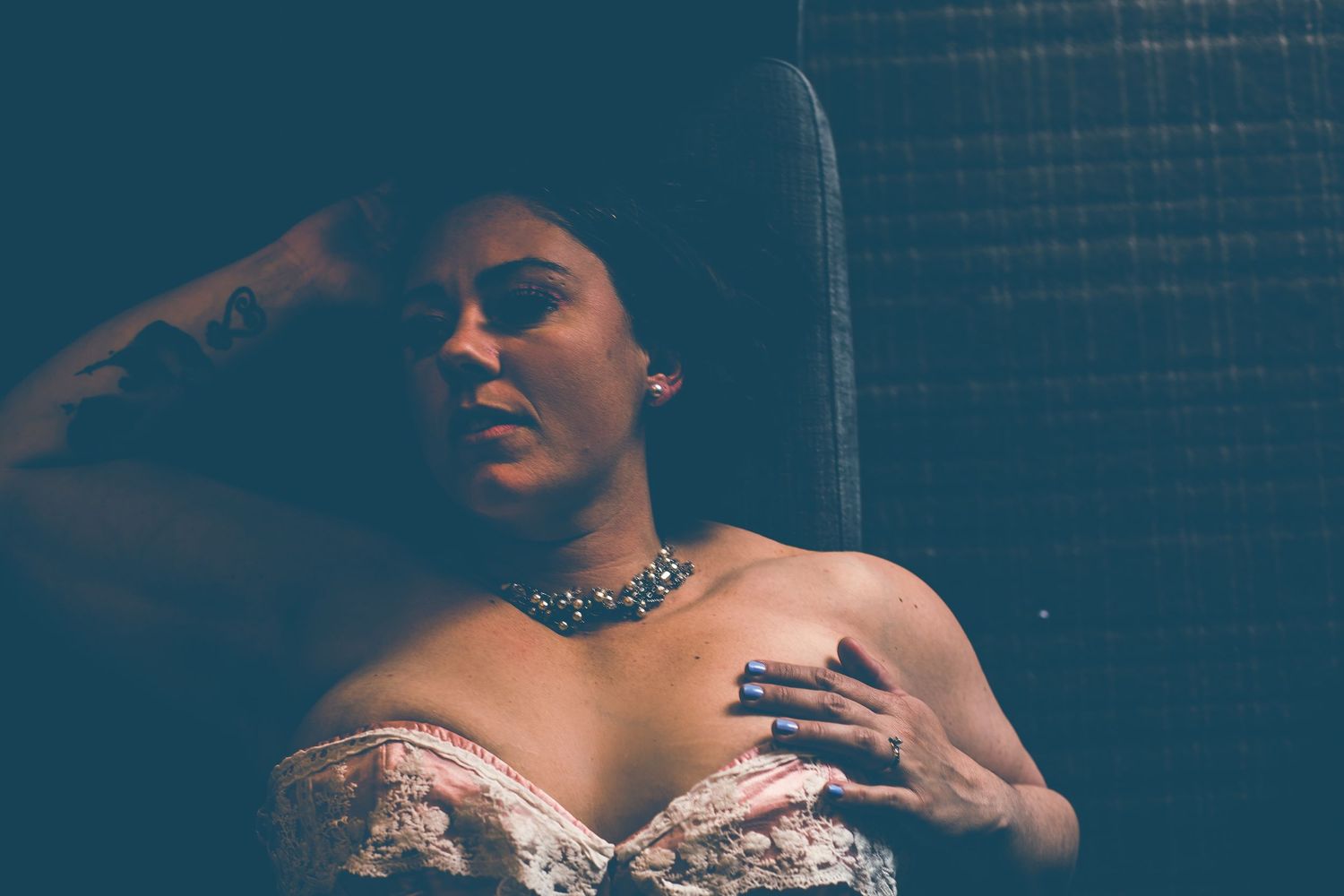 Moody portrait in vintage style featuring sparkly necklace and strapless dress.