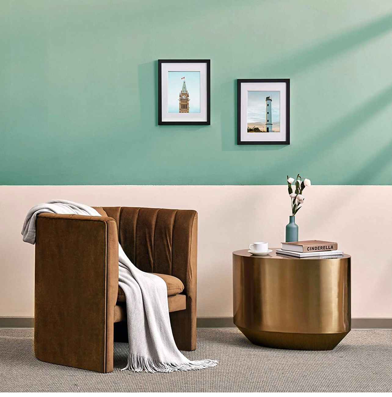 Modern living room with teal accent wall, brown velvet chair, gold side table, and framed art.