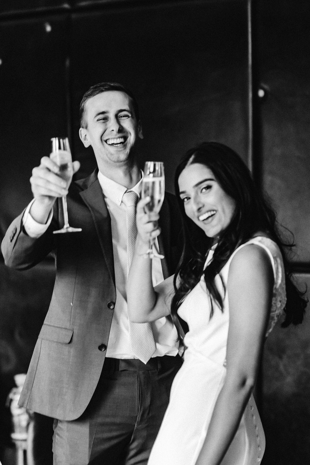 Bride and groom saying cheers looking very very happy