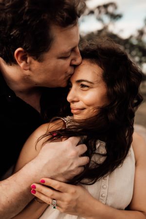 Intimate romantic moment captured in warm tones with natural lighting.