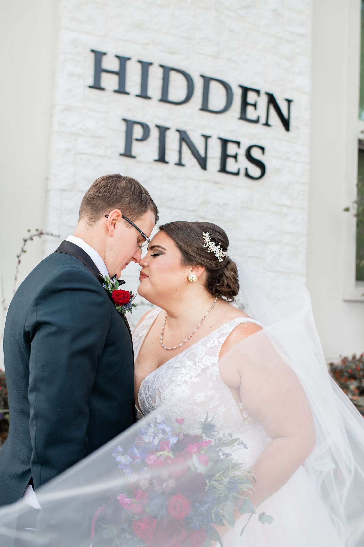 Bride and groom kiss at Hidden Pines Hurst wedding in Texas.