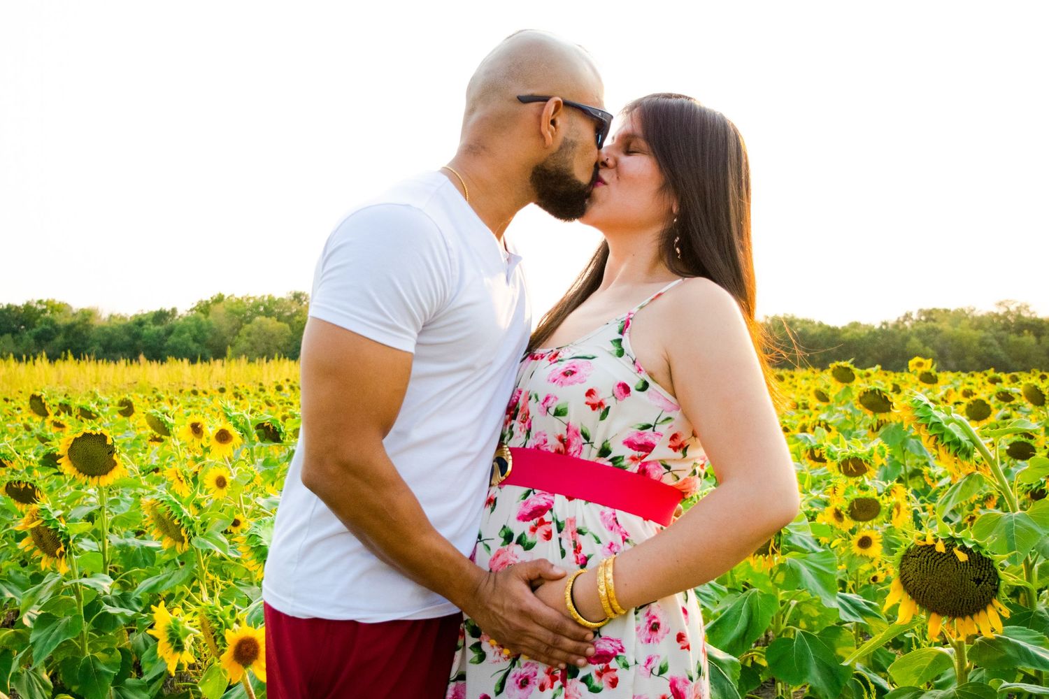 Couple during Maternity session in Sunflower field, Richmond, MO. Kansas City Area.