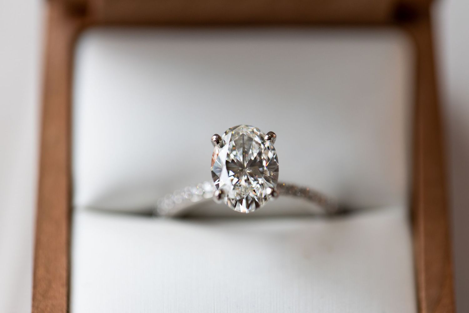 Elegant oval diamond solitaire engagement ring in white gold setting.