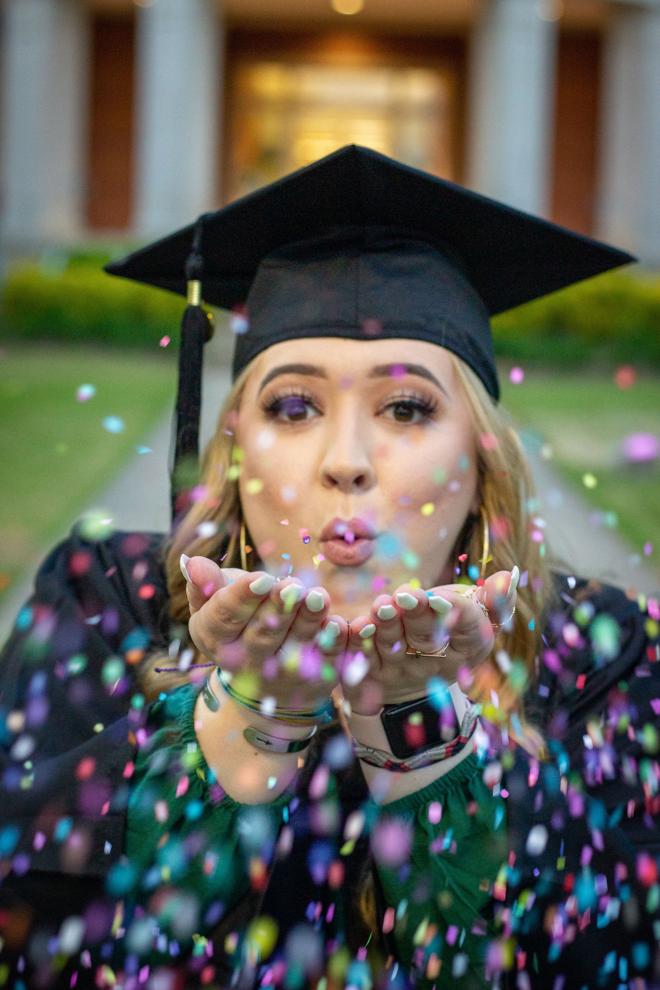 female graduate cap and gown glitter shot