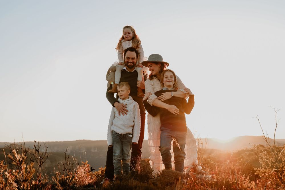 Group enjoying sunset views from a scenic mountain overlook.