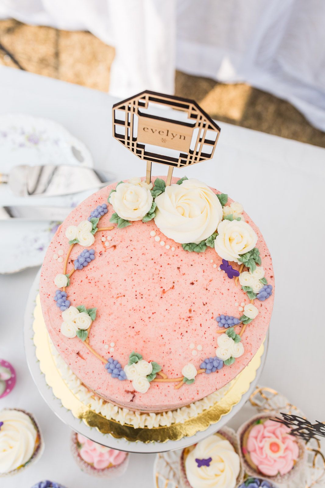 Pink birthday cake and cupcakes at girls birthday party