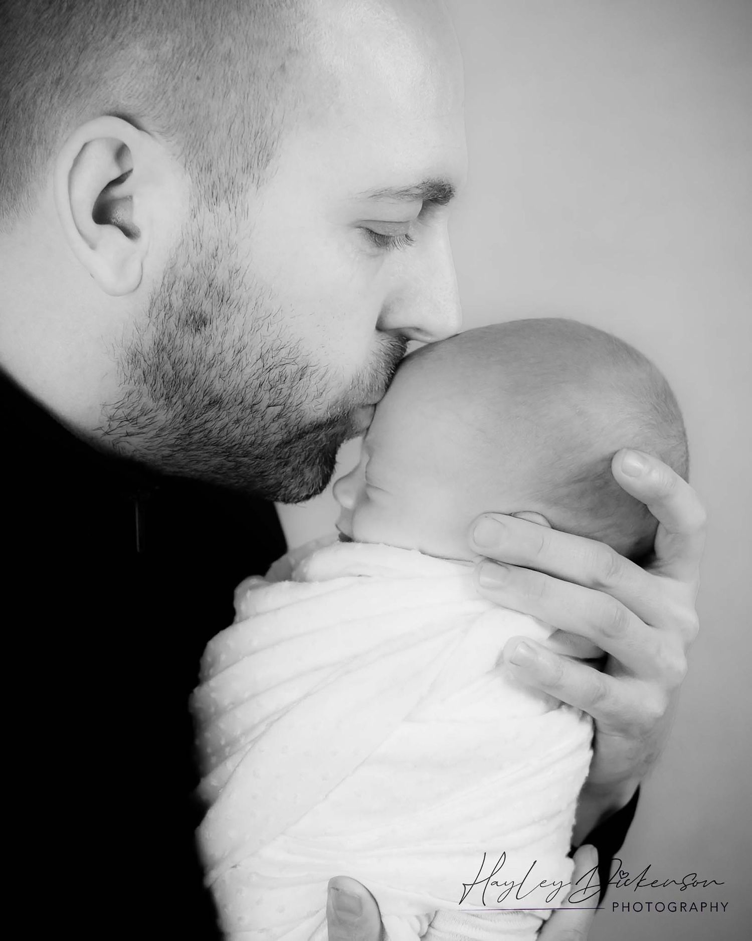 Hayley Dickenson Photography Family - dad kissing newborn baby girl's head