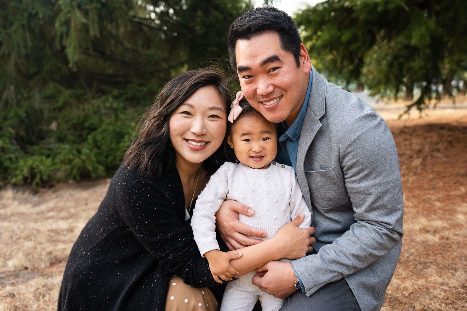 Seattle family photographer capturing posed smiling family portrait.