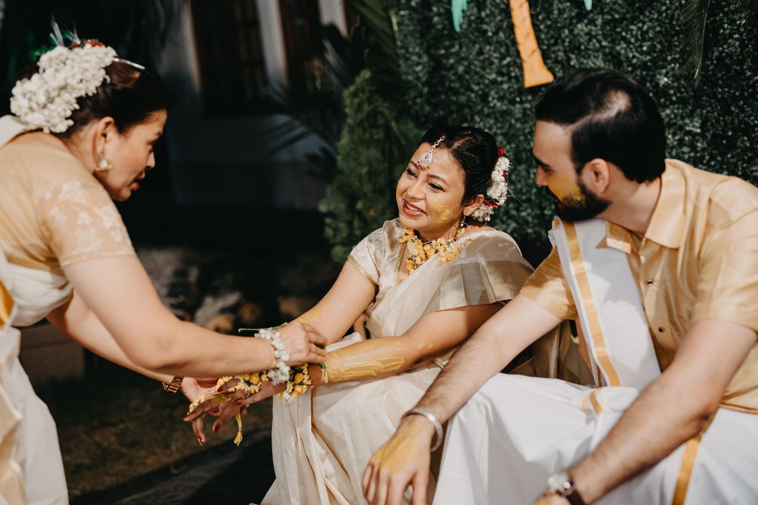Wedding party celebrates with energetic dancing and laughter at nighttime reception.