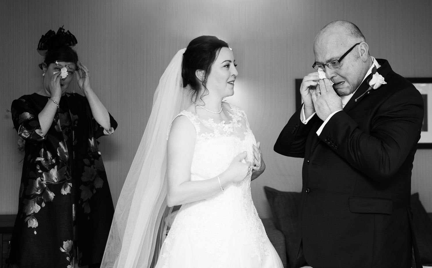 An emotional black and white moment captured during a wedding ceremony.