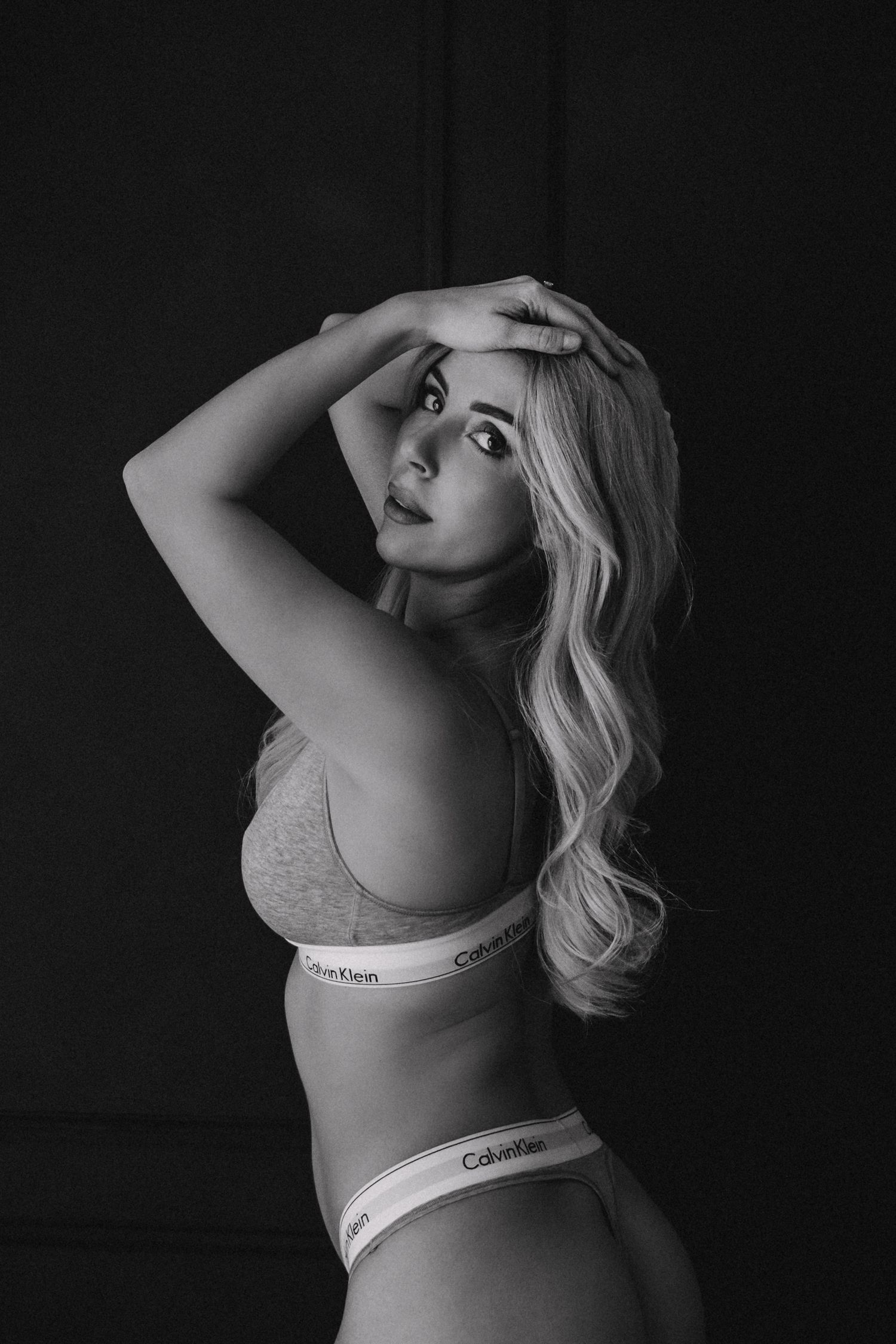 black and white boudoir photo of woman in calvin klein underwear