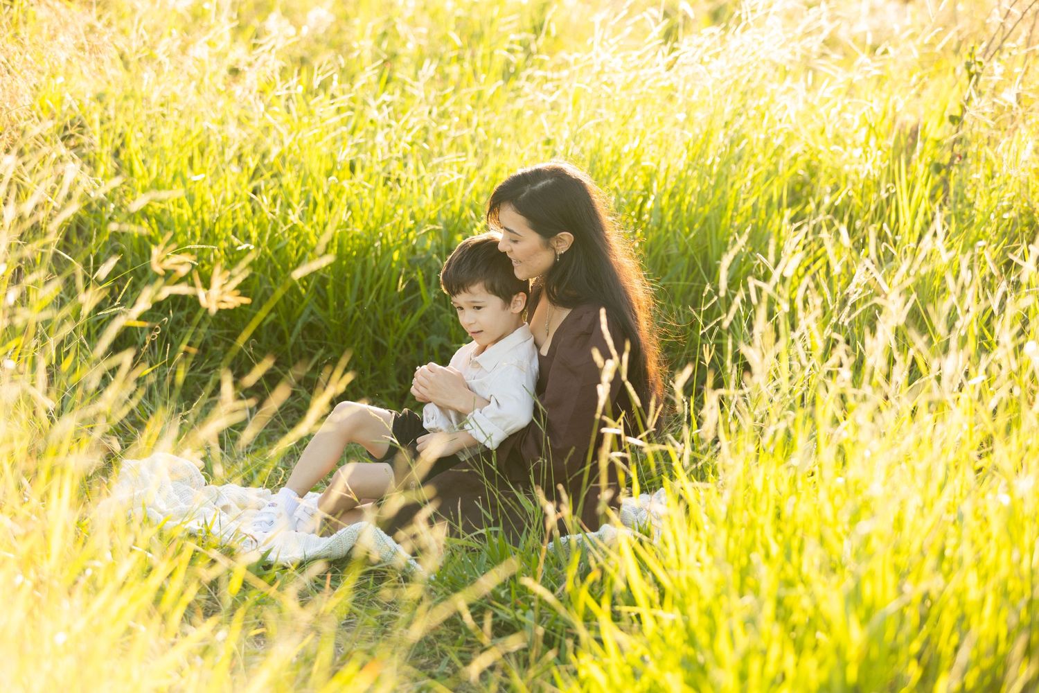 mother and son outdoor portrait in the long grass