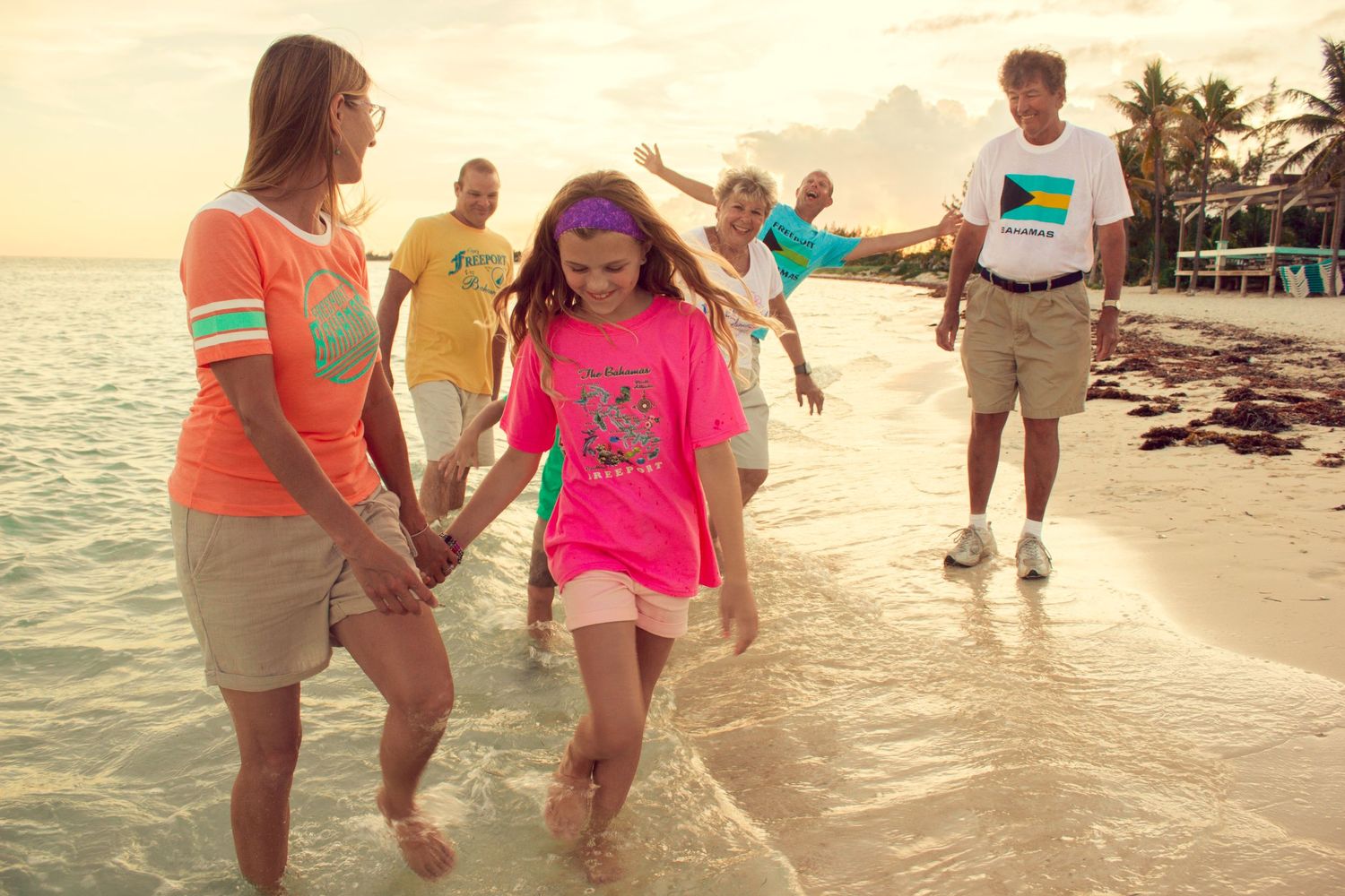 Family on beach shoreline playing in water, nassau bahamas photographer, K. Yolanda Turnquest Photography