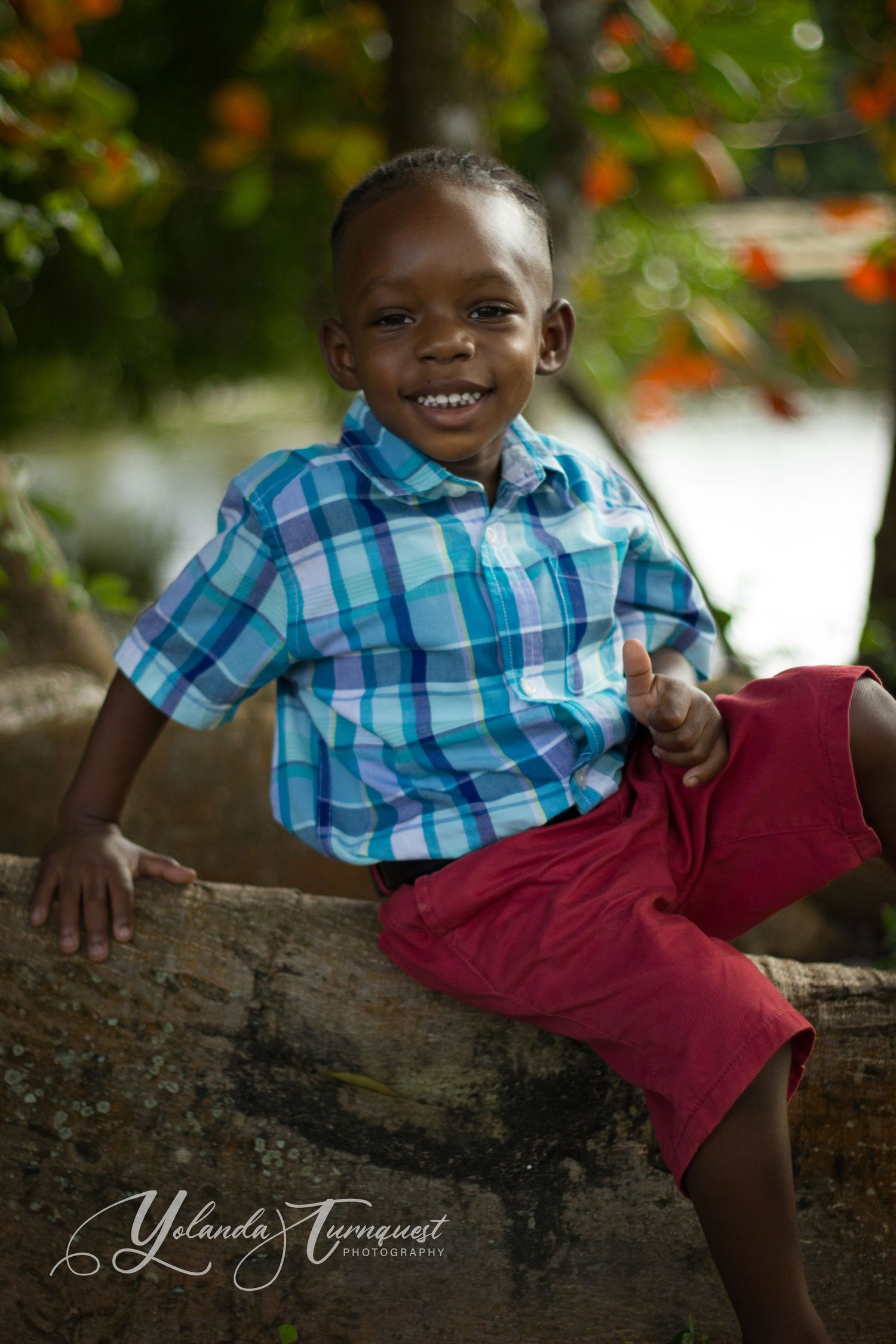 boy on log near pond nassau bahamas photographer