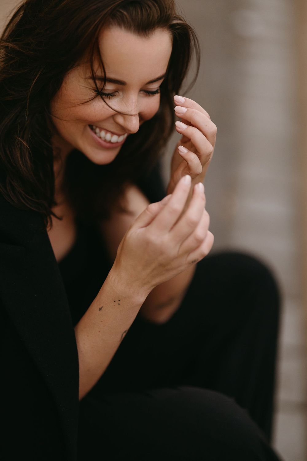 Intimate portrait showing genuine laughter and natural emotion in warm lighting.