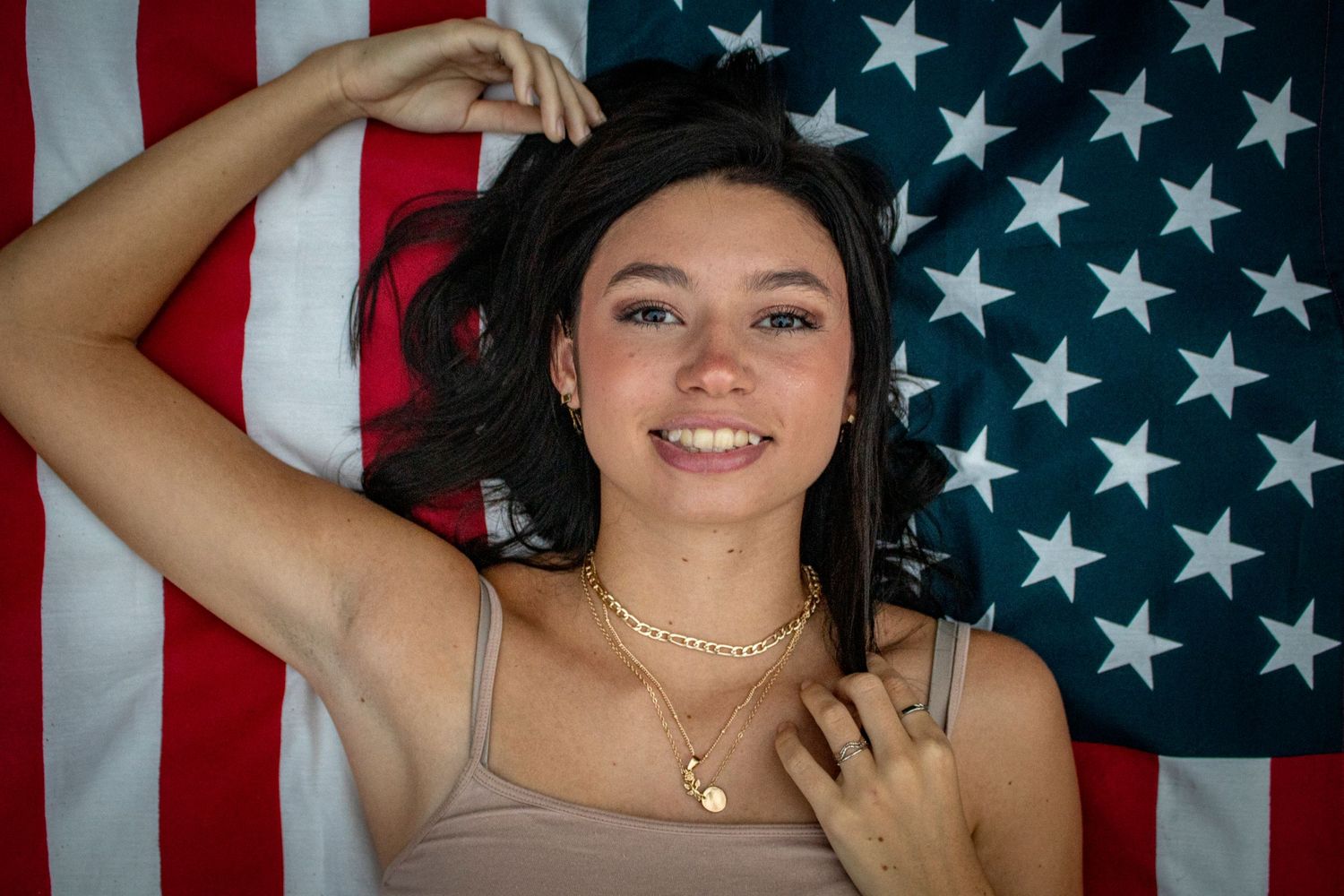 young lady laying on an American Flag