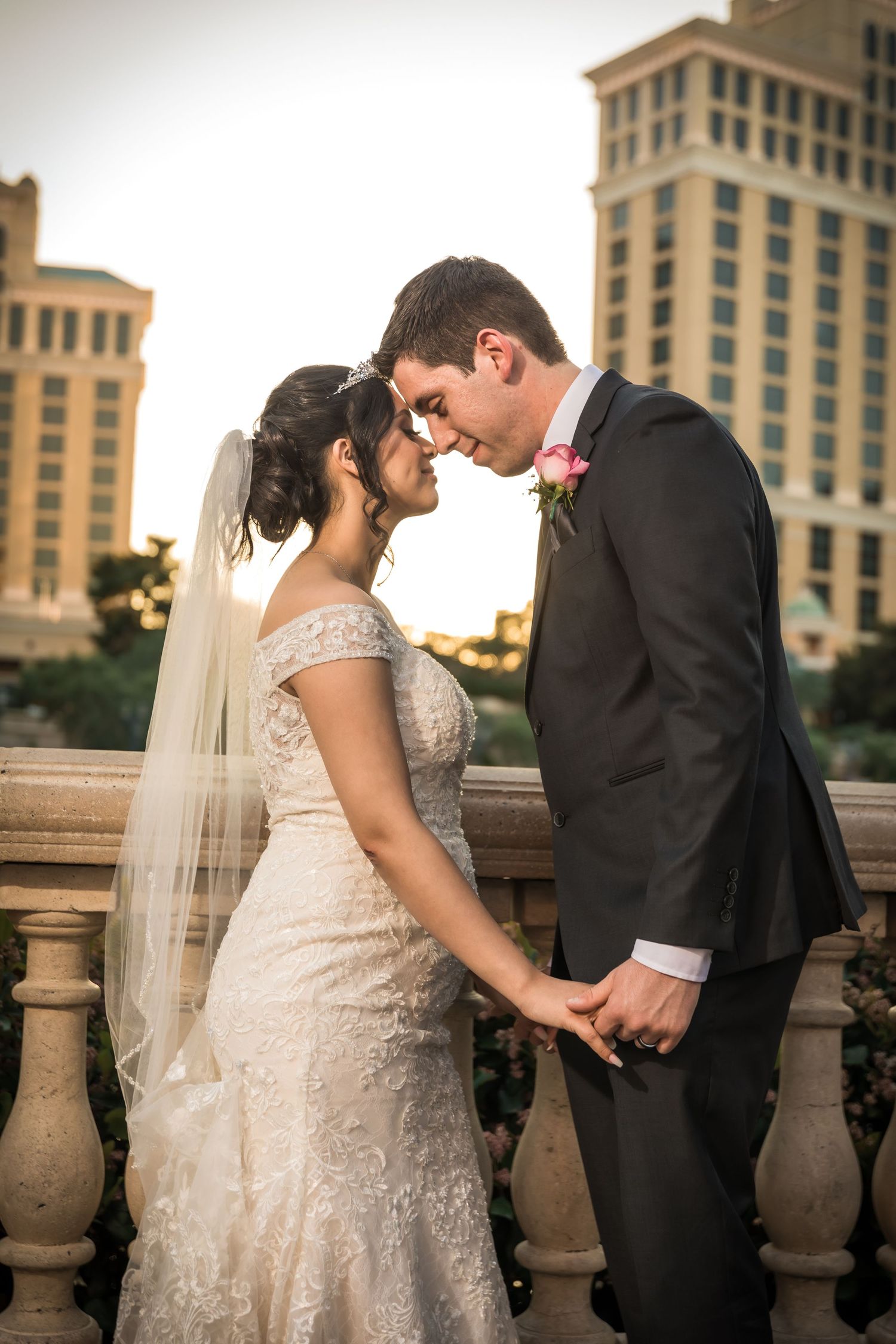 A tender moment captured between a couple at a luxurious architectural setting.