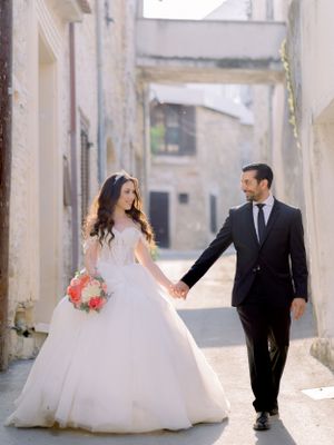 bride and groom walking in hands in the streets of lefkara village