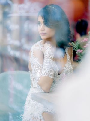 a beautiful bride naturally looking out of the window in Limassol