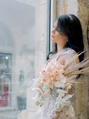 a gorgeous bride elegantly looking out of the window in Limassol