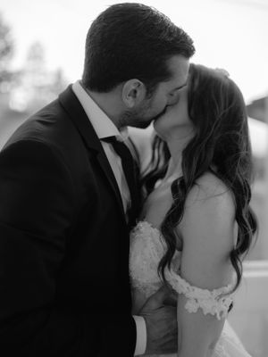 bride and groom kissing passionately