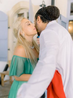 a Cypriot groom getting kissed by his godmother at his wedding