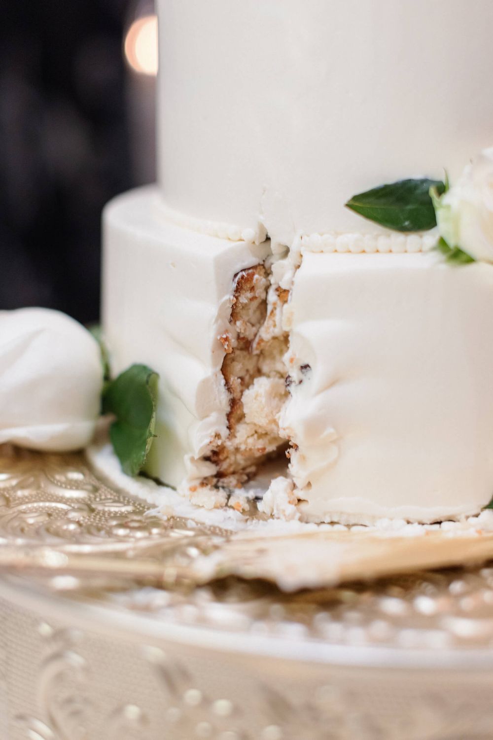 Close-up of a sliced white wedding cake showing layers and texture.