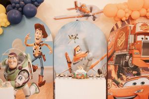 Toy Story themed party decoration banner with colorful cartoon characters.