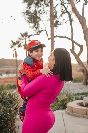 A joyful outdoor moment captured in front of palm trees during golden hour.