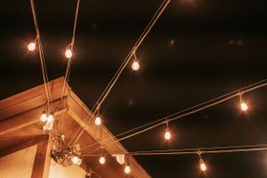 String lights hung against a dark night sky creating a warm ambient glow.