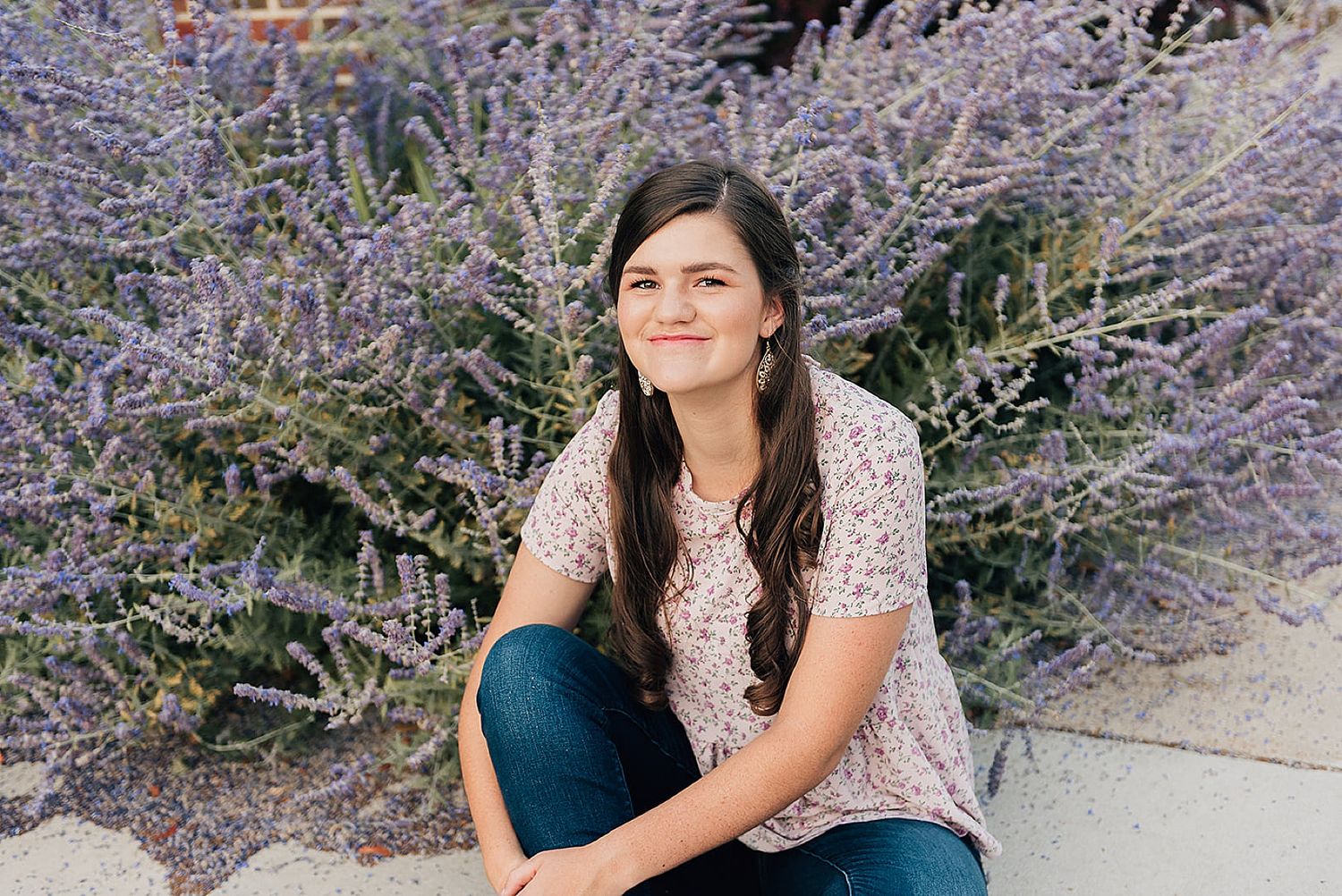 Casual outdoor portrait among blooming purple Russian sage plants.