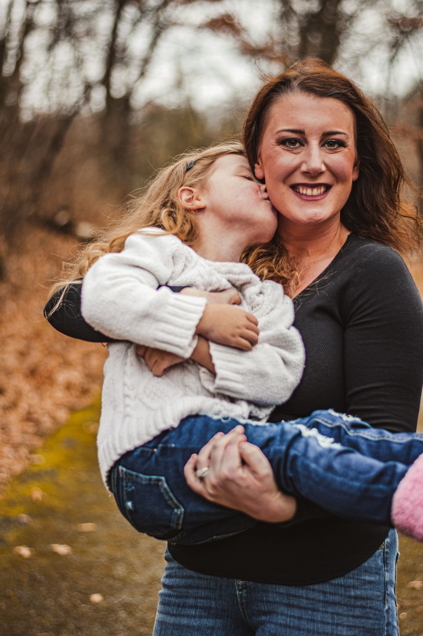 A tender moment captured outdoors during autumn.